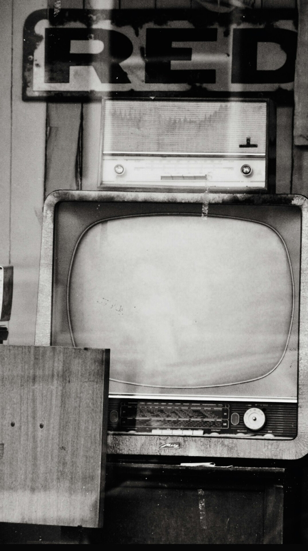 Vintage television set displaying a black and white advertisement