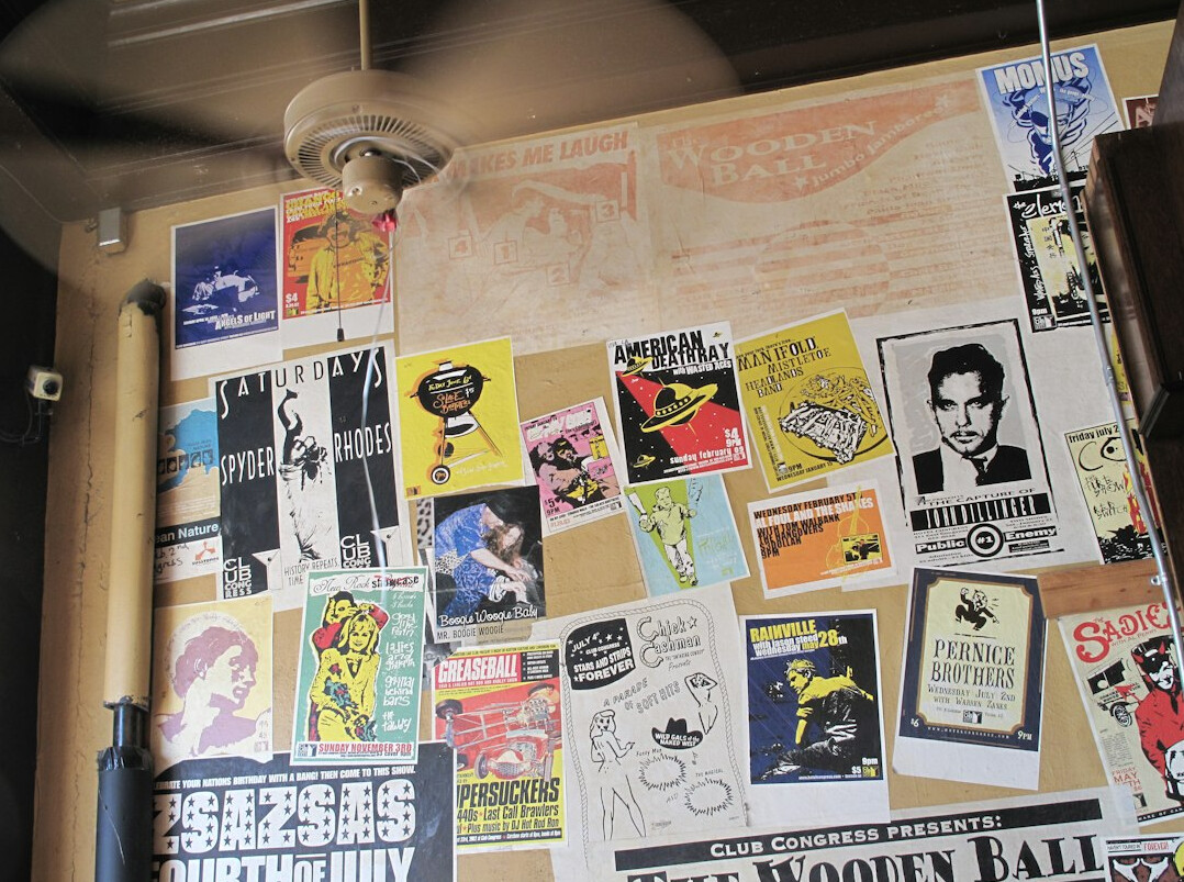 Wall covered with vintage advertising posters and magazine clippings